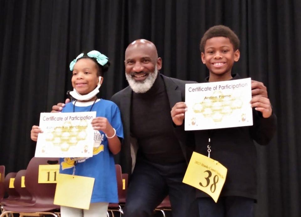 Jackson Public Schools Superintendent Errick Greene, Ph.D., congratulates Hinds County Spelling Bee champion Ashlynn-Kai McClinton (left) and first runner up Arden Pierre (right).
