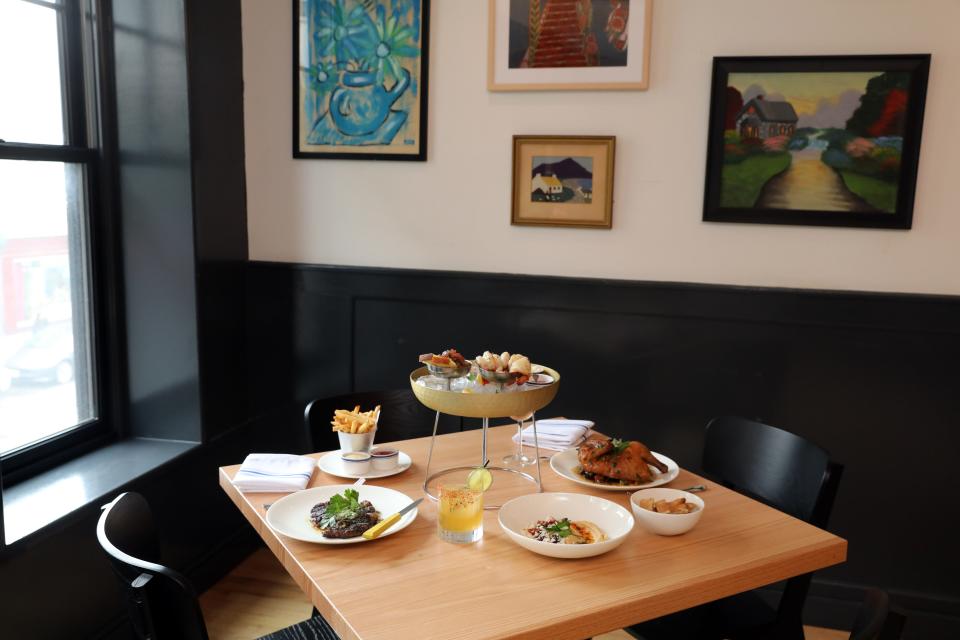 Menu items include a Rib-Eye Steak Frites, Simply Roasted Half Chicken, a raw bar trio and hummus bowl at the new Town House Kitchen + Drinks in New Rochelle May 15, 2024.