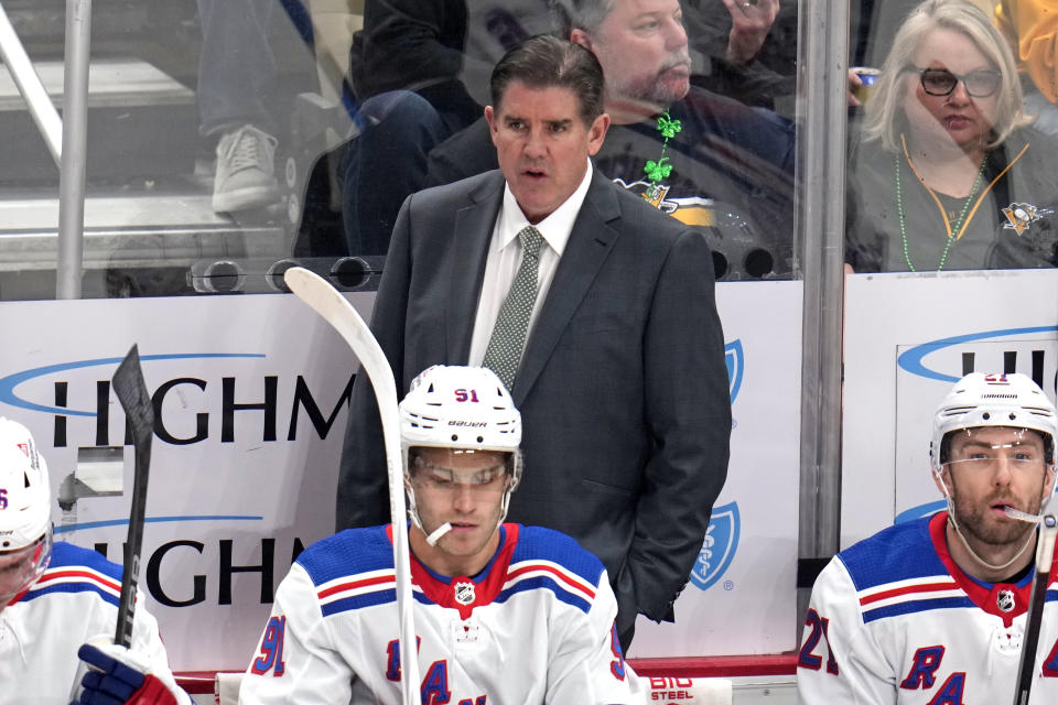 New York Rangers head coach Peter Laviolette stands behind his bench during the first period of an NHL hockey game against the Pittsburgh Penguins in Pittsburgh, Saturday, March 16, 2024. The Rangers won 7-4. (AP Photo/Gene J. Puskar)