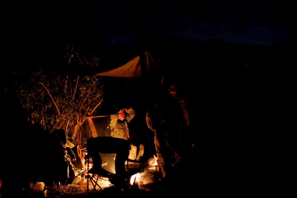 Soldiers camp near the area where they found an illegal opium plantation