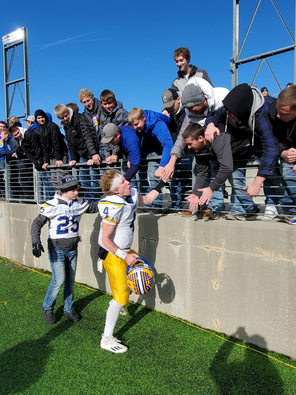 Marion Local quarterback Peyton Otte celebrates the Flyers' state-record 12th OHSAA football state championship with fans after beating Newark Catholic on Saturday, Dec. 4, 2021, at Tom Benson Hall of Fame Stadium.