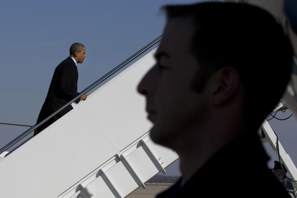 President Barack Obama boards Air Force One at Andrews Air Force Base, Md., Friday, Feb. 7, 2014, prior to departure to Michigan where he is expected to speak about the farm bill. (AP Photo/Jacquelyn Martin)