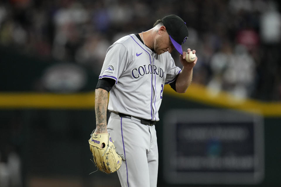 Colorado Rockies starting pitcher Kyle Freeland pauses on the pitcher's mound during the third inning of the team's baseball game against the Arizona Diamondbacks on Thursday, March 28, 2024, in Phoenix. (AP Photo/Ross D. Franklin)