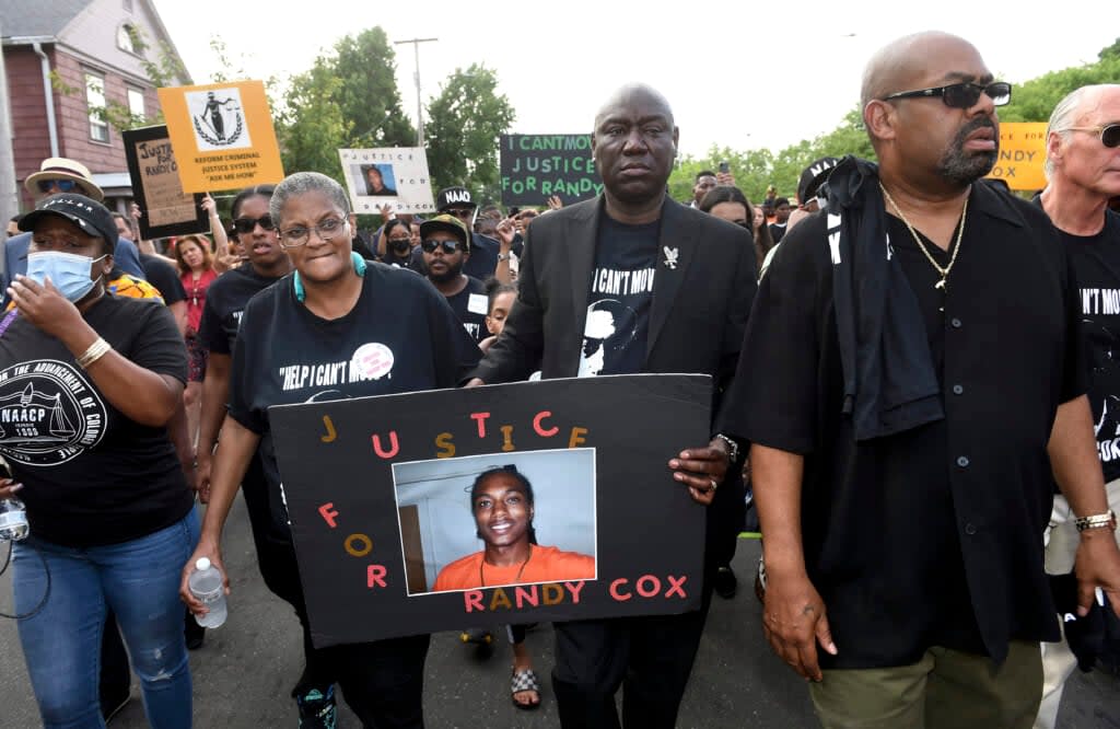 Doreen Coleman, left, mother of Richard “Randy” Cox Jr., walks with civil rights attorney Benjamin Crump during a march for Justice for Randy Cox on Dixwell Avenue in New Haven, Conn., Friday, July 8, 2022. (Arnold Gold/New Haven Register via AP, File)