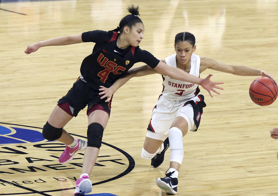 Stanford guard Anna Wilson (3) drives as Southern California guard Endyia Rogers (4) defends during an NCAA college basketball game in the second round of the Pac-12 women's tournament Thursday, March 4, 2021, in Las Vegas. (AP Photo/Isaac Brekken)