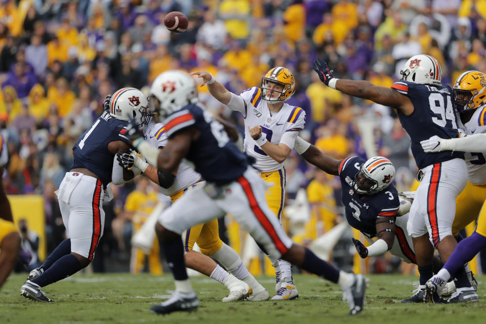 LSU quarterback Joe Burrow (9) passes under pressure from Auburn defensive end Marlon Davidson (3) in the first half of an NCAA college football game in Baton Rouge, La., Saturday, Oct. 26, 2019. (AP Photo/Gerald Herbert)