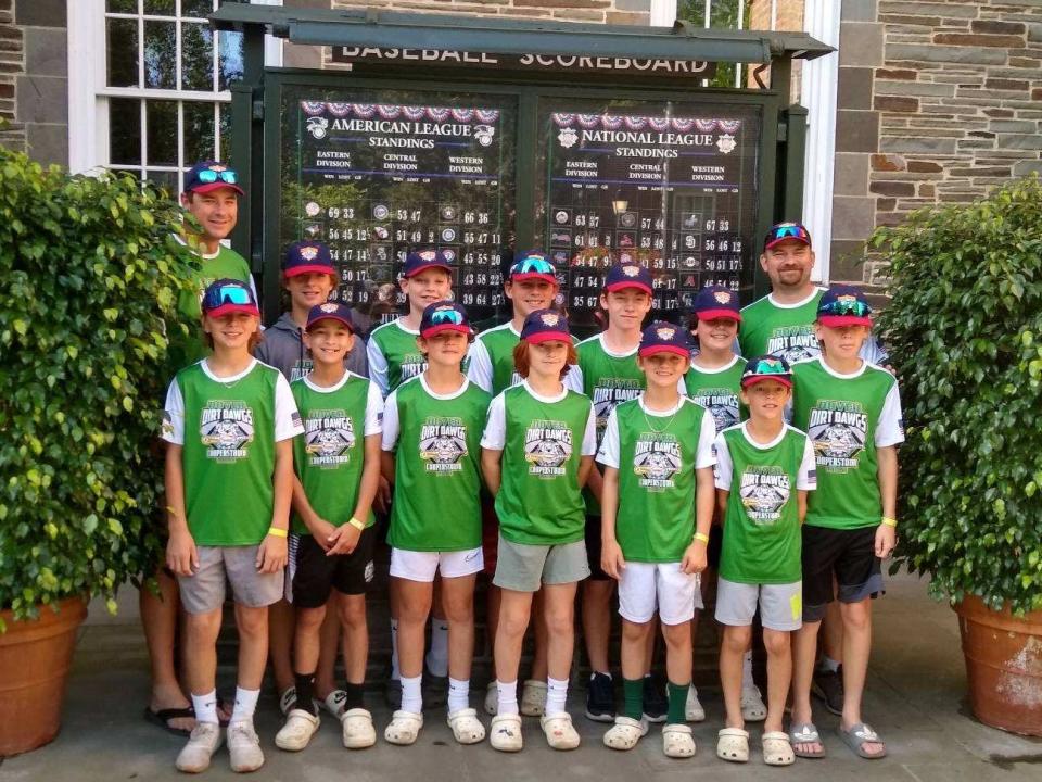 Members of the Dover Dirt Dawgs pose outside the Baseball Hall of Fame in Cooperstown, New York.