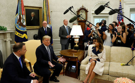 U.S. President Donald Trump speaks next to first lady Melania Trump during a meeting with Poland's President Andrzej Duda (L) in the Oval Office of the White House in Washington, U.S., September 18, 2018. REUTERS/Kevin Lamarque