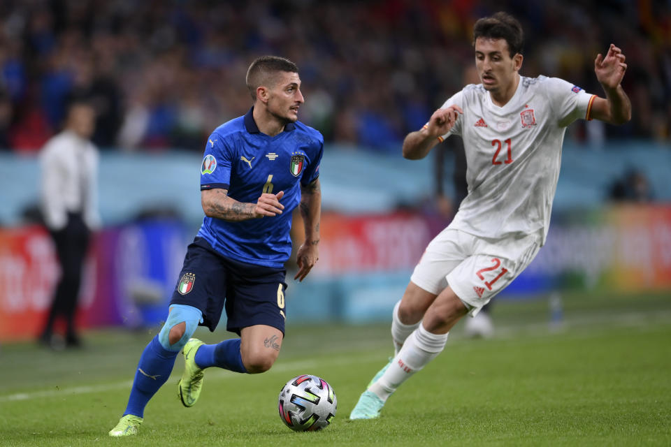 Italy's Marco Verratti, left, takes on Spain's Mikel Oyarzabal during the Euro 2020 soccer semifinal match between Italy and Spain at Wembley stadium in London, Tuesday, July 6, 2021. (Laurence Griffiths, Pool via AP)