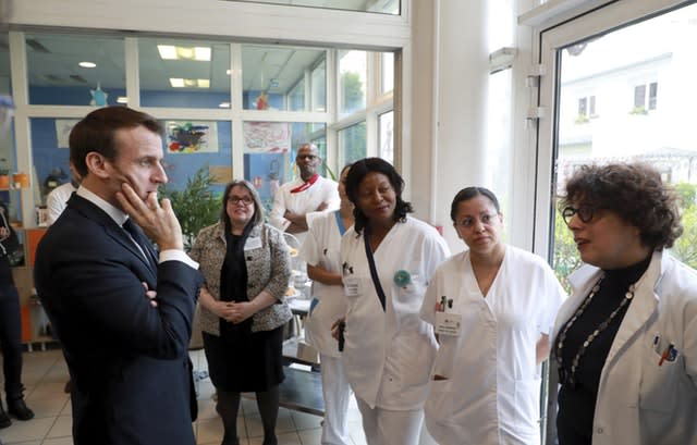 Emmanuel Macron meets  staff at a care home in Paris