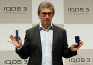 Philip Morris International's CEO Andre Calantzopoulos poses with its new IQOS 3 devices at a news conference in Tokyo, Japan, October 23, 2018. REUTERS/Kim Kyung-Hoon