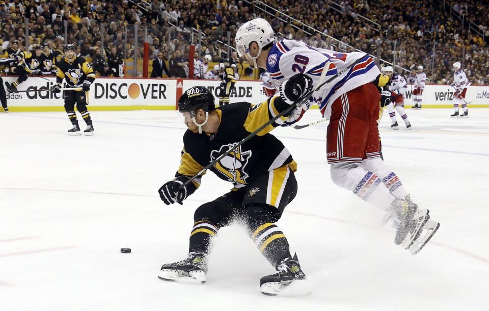 New York Rangers left wing Chris Kreider (20) attempts to skate around a check by Pittsburgh Penguins defenseman Mike Matheson (5) during Game 6 of the first round of the NHL playoffs.