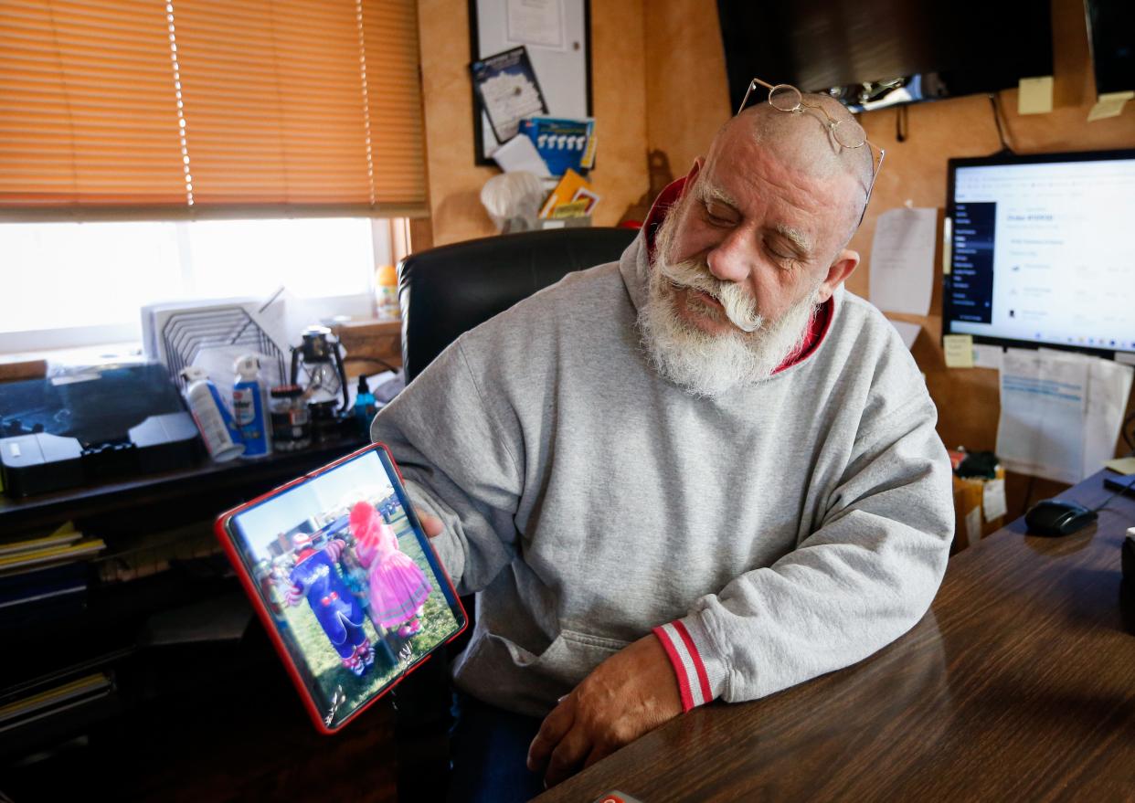 Spangle the Clown shares a photograph of him with his late wife Daisy Mae at his office in Fair Grove on Wednesday, Dec. 28, 2022. Spangle and Daisy performed as clowns and Santa Claus and Mrs. Claus together. Daisy died in a car accident in March 2022.