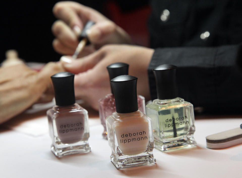 CORRECTS DATE TO AUG. 16 - This Aug. 16, 2012 photo shows ail polish by Deborah Lippman is applied in her Mini-Mani demonstration at the International Spa Association event, in New York. Parties at the spa, treatments for stressed and time-pressed consumers, cross-cultural traditions, and a whole lot of purple _ from lavender-scented treatments to mauve nail polish _ are some of the trends and services that were shown off at the annual International Spa Association meeting held recently in New York. (AP Photo/Richard Drew)