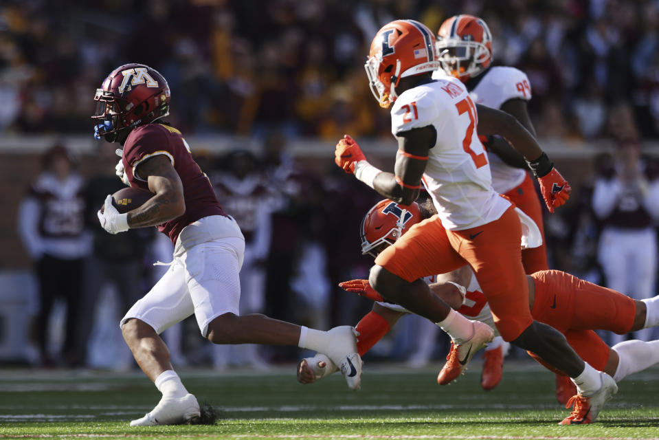Minnesota wide receiver Chris Autman-Bell (7) carries the ball against Illinois defense during the first half of an NCAA college football game Saturday, Nov. 6, 2021, in Minneapolis. (AP Photo/Stacy Bengs)