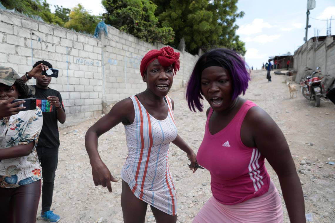 Relatives of Haitian churchgoers killed during a religious march the day before express their anger Sunday in front of the church. Odelyn Joseph/AP