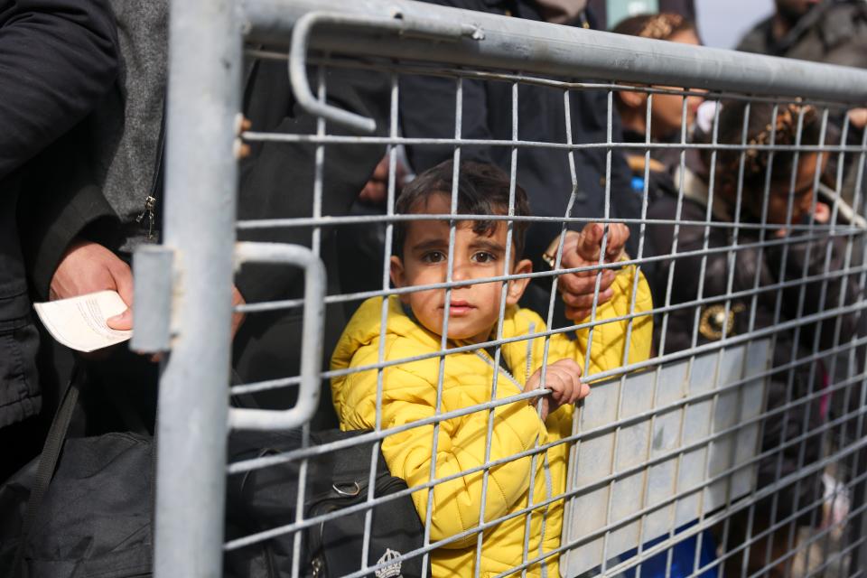 Syrians wait to cross into Syria from Turkey at the Cilvegozu border gate, near the town of Antakya, southeastern Turkey, Tuesday, Feb. 21, 2023. The death toll in Turkey and Syria rose to eight in a new and powerful earthquake that struck two weeks after a devastating temblor killed nearly 45,000 people, authorities and media said Tuesday.