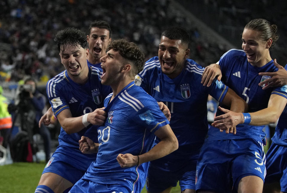 Italy's Simone Pafundi, front, celebrates with teammates after scoring his side's second goal against South Korea during a FIFA U-20 World Cup semifinal soccer match at Diego Maradona stadium in La Plata, Argentina, Thursday, June 8, 2023. (AP Photo/Natacha Pisarenko)