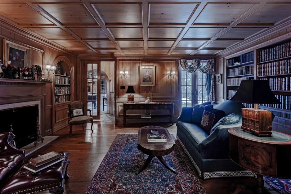 There are original details throughout, such as this wood-paneled library. Cara Miller