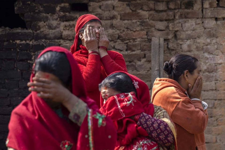 A group of women mourners cry during the final rites procession of Hari Aryal (EPA)