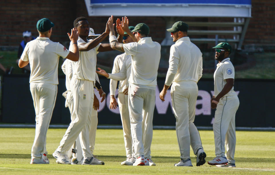 South Africa's Kagiso Rabada, second from left, celebrates with teammates after dismissing Sri Lanka's captain Dimuth Karunaratne for 17 runs on day one of the second cricket test match between South Africa and Sri Lanka at St. George's Park in Port Elizabeth, South Africa, Thursday Feb. 21, 2019. (AP Photo/Michael Sheehan)
