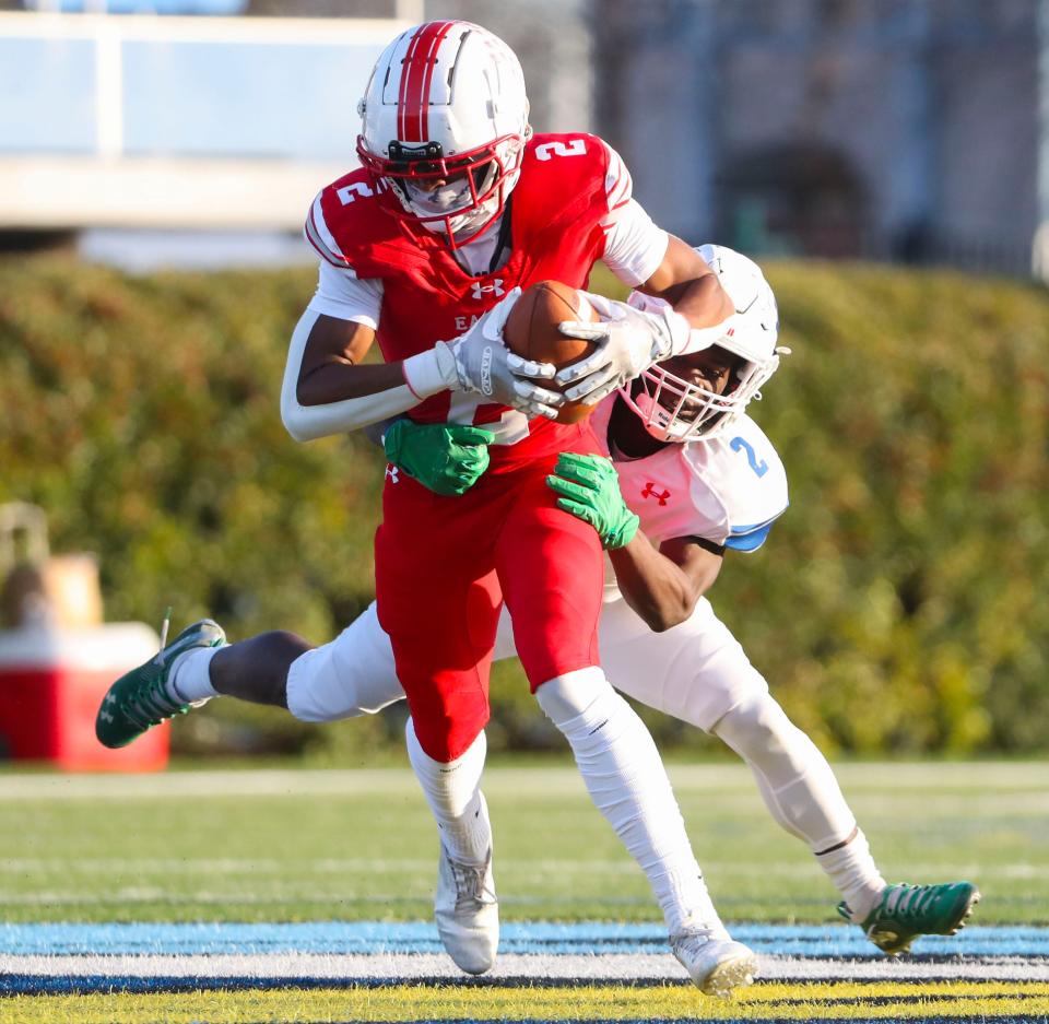 Smyrna's Joshua Gueh is hit on the opening kickoff by Dover's Tyron Abrams in the DIAA Class 3A championship at Delaware Stadium, Saturday, Dec. 10, 2022.