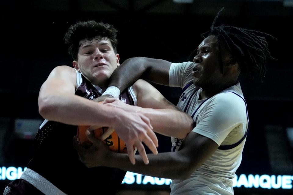 La Salle's Rex Zadrozny and Classical's Jordan Duke fight for a rebound in the second half of Sunday's championship game.