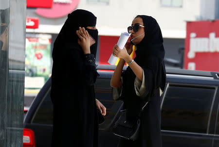 Saudi women speak on phones in Riyadh, Saudi Arabia September 27, 2017. REUTERS/Faisal Al Nasser