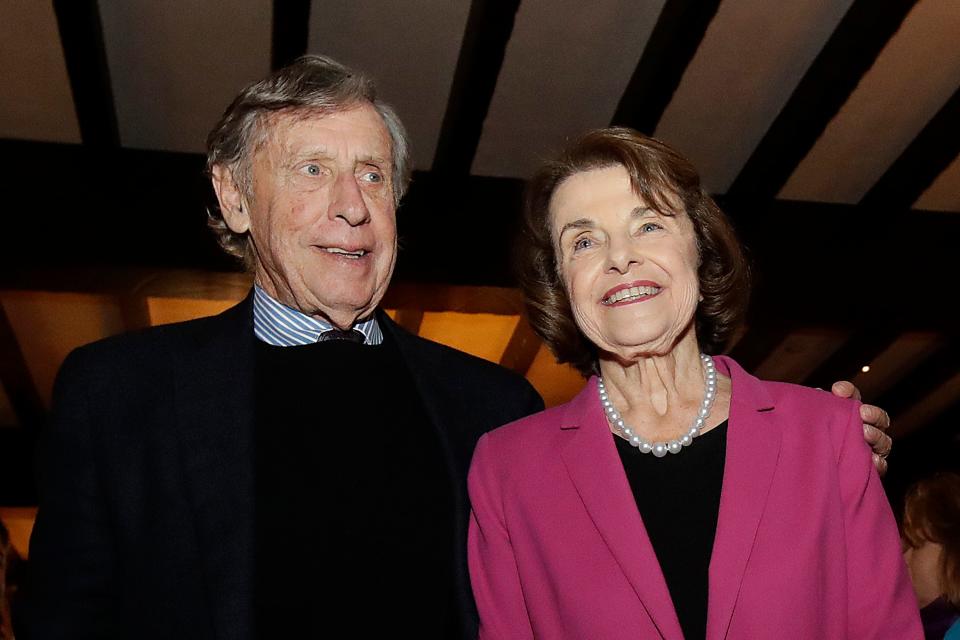 FILE - In this Nov. 6, 2018, file photo, U.S. Sen. Dianne Feinstein, right, smiles next to husband Richard Blum at an election night event in San Francisco.