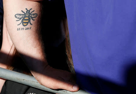 A man is seen with a bee tattoo during a choir concert on the first anniversary of the Manchester Arena bombing, in Manchester, Britain, May 22, 2018. REUTERS/Andrew Yates