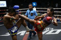 Muay Thai boxer Nong Rose Baan Charoensuk (R), 21, who is transgender, kicks Priewpak Sorjor Wichit-Padrew during a boxing match at the Rajadamnern Stadium in Bangkok, Thailand, July 13, 2017. REUTERS/Athit Perawongmetha