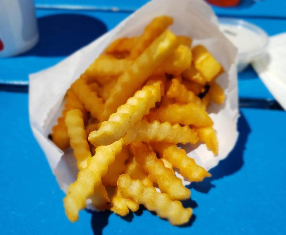 The crinkle-cut fries are crispy and well-seasoned at Tiki Teriyaki Burger Time.