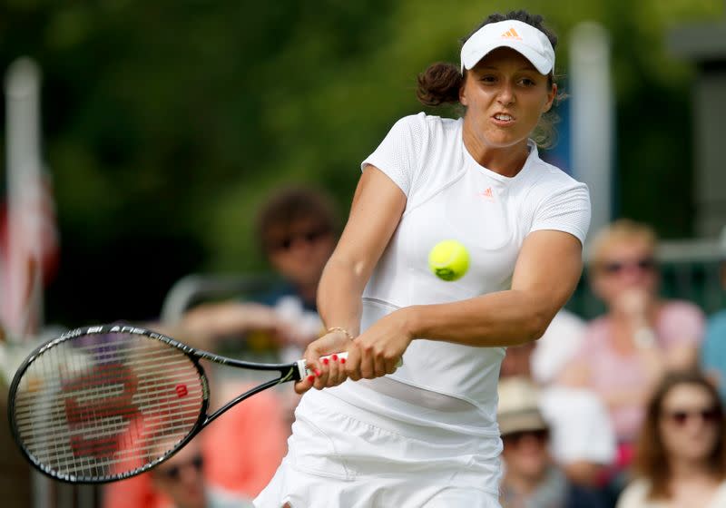 Laura Robson of Britain hits a return to Francesca Schiavone of Italy and Samantha Stosur of Australia, with her partner Lisa Raymond of the U.S., in their women's doubles tennis match at the Wimbledon Tennis Championships, in London