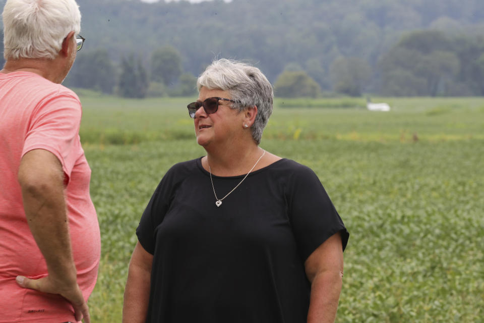 Jane Alsup, right, talks with Jackie Murry, left, about the airplane that crash-landed in a field near her Ripley, Miss. home on Saturday, Sept. 3, 2022. Authorities say a man who stole a plane and flew it over Mississippi after threatening to crash it into a Walmart store faces charges of grand larceny and terroristic threats. Tupelo Police Chief John Quaka said Cory Wayne Patterson didn't have a pilot's license but had some flight instruction and was an employee of Tupelo Aviation. (AP Photo/Nikki Boertman)