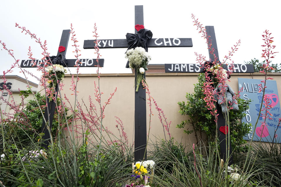 FILE - Crosses with the names, Cindy Cho, Kyu Cho and James Cho, who were victims of a mass shooting stand at a makeshift memorial by the mall where several people were killed, Wednesday, May 10, 2023, in Allen, Texas. Their family's only survivor that day was their 6-year-old son. Those who knew Kyu and Cindy Cho say the two complemented each other perfectly. (AP Photo/Tony Gutierrez, File)