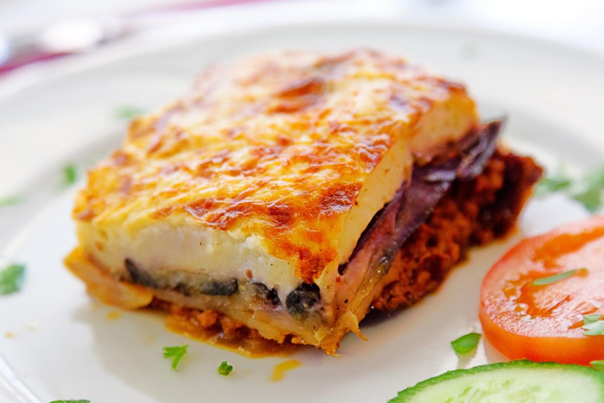 Closeup of Easy Eggplant Moussaka on a white porcelain plate, selective focus, blurred background