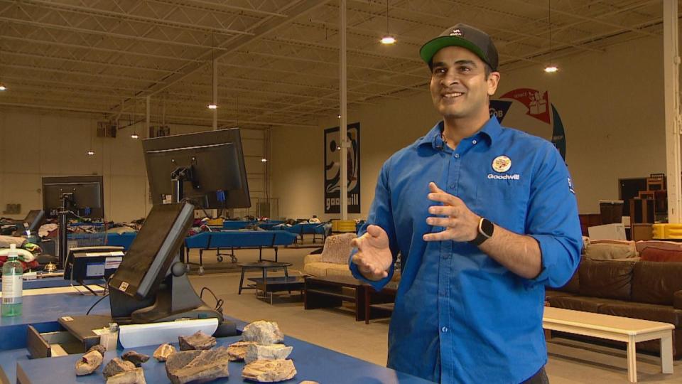 Daoud Abbasi works at Goodwill in Calgary. He recently came across a very old box of donated items. (Monty Kruger/CBC - image credit)