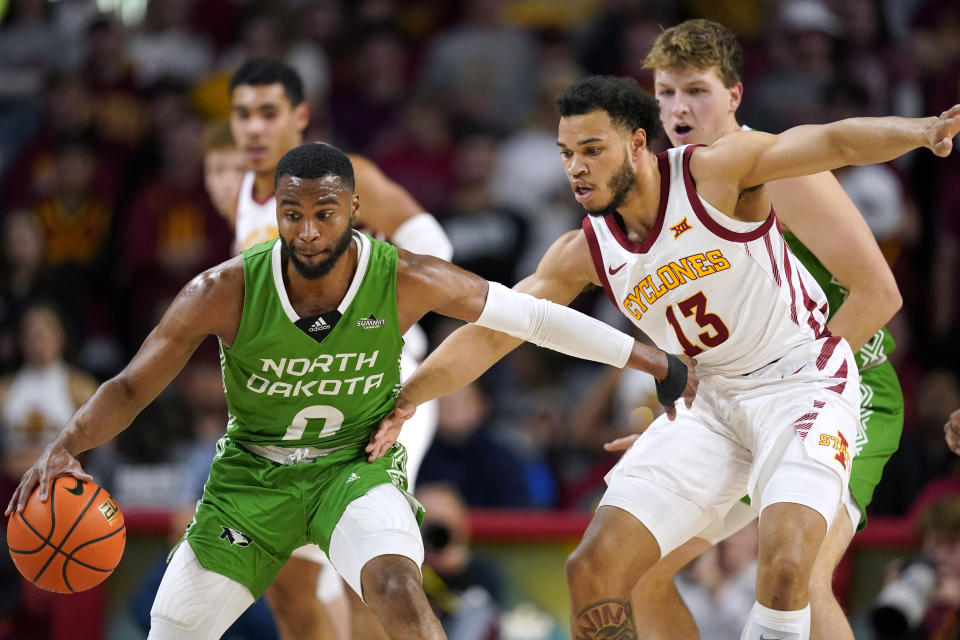 North Dakota guard Caleb Nero (0) drives around Iowa State guard Jaren Holmes (13) during the first half of an NCAA college basketball game, Wednesday, Nov. 30, 2022, in Ames, Iowa. (AP Photo/Charlie Neibergall)