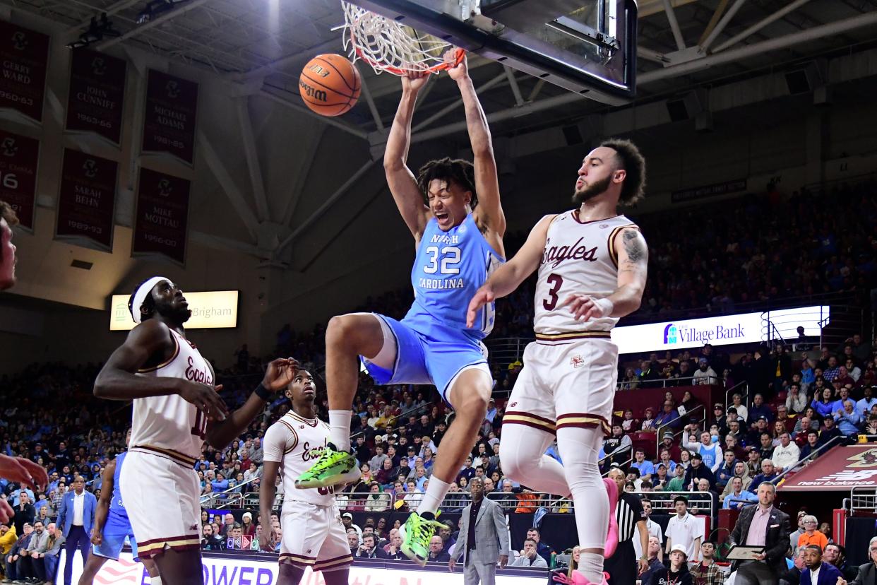 North Carolina forward James Okonkwo hangs from the rim after dunking at Boston College during the first half, Jan. 20, 2024.