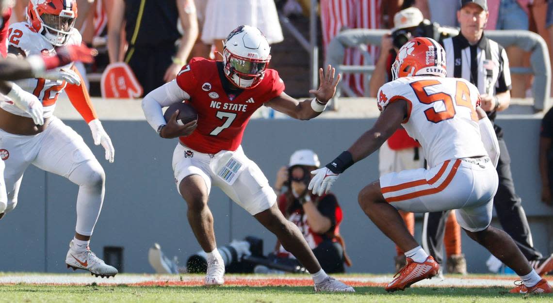 N.C. State quarterback MJ Morris (7) scrambles to avoid a sack during the first half of N.C. State’s game against Clemson at Carter-Finley Stadium in Raleigh, N.C., Saturday, Oct. 28, 2023. Ethan Hyman/ehyman@newsobserver.com