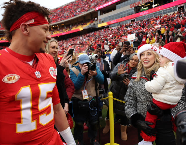 KANSAS CITY, MISSOURI – DECEMBER 25: Patrick Mahomes #15 of the Kansas City Chiefs greets his wife Brittany and daughter Sterling Skye prior to a game against the Las Vegas Raiders at GEHA Field at Arrowhead Stadium on December 25, 2023 in Kansas City, Missouri. <em>Photo by Jamie Squire/Getty Images.</em>