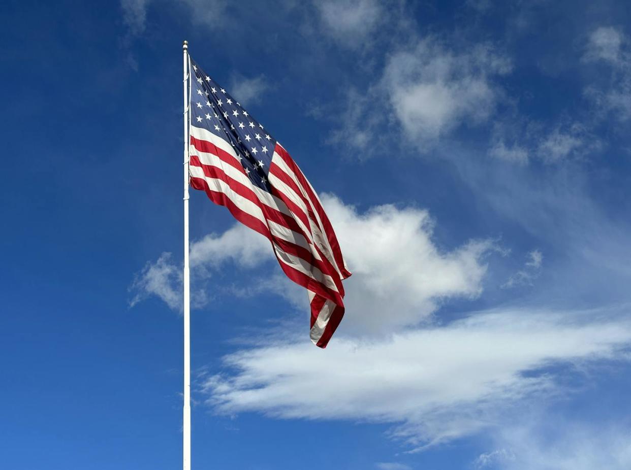 The anniversary of the adoption of the U.S. flag is celebrated each year on June 14. <a href="https://www.gettyimages.com/detail/photo/american-flag-blowing-in-the-wind-with-a-partly-royalty-free-image/1490609343?phrase=american+flag&searchscope=image%2Cfilm&adppopup=true" rel="nofollow noopener" target="_blank" data-ylk="slk:tiaramaio/RooM via Getty images;elm:context_link;itc:0;sec:content-canvas" class="link ">tiaramaio/RooM via Getty images</a>