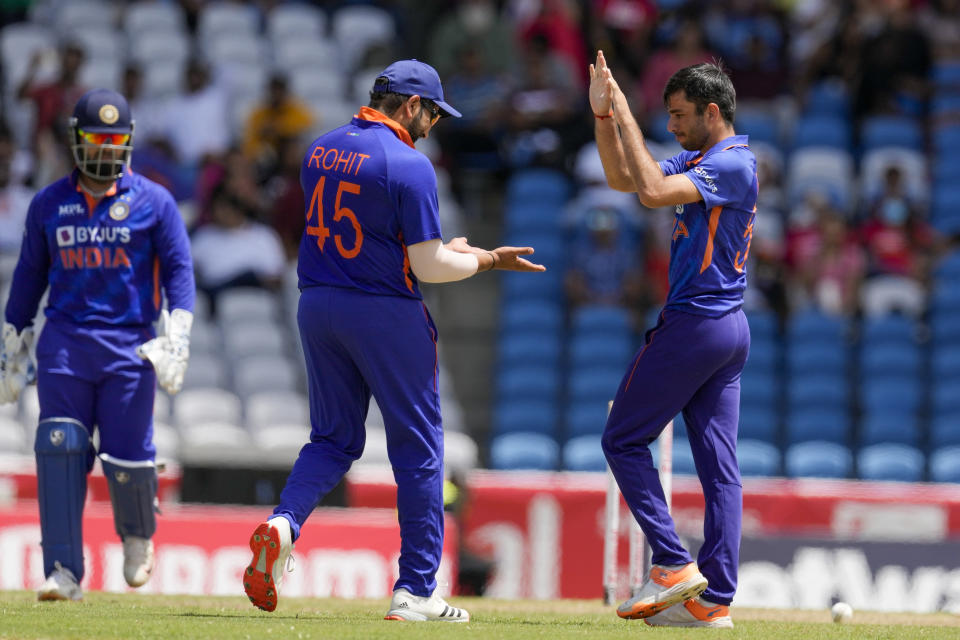 India's Ravi Bishnoi celebrates with captain Rohit Sharma after he bowled West Indies' Rovman Powell during the first T20 cricket match at Brian Lara Cricket Academy in Tarouba, Trinidad and Tobago, Friday, July 29, 2022. (AP Photo/Ricardo Mazalan)
