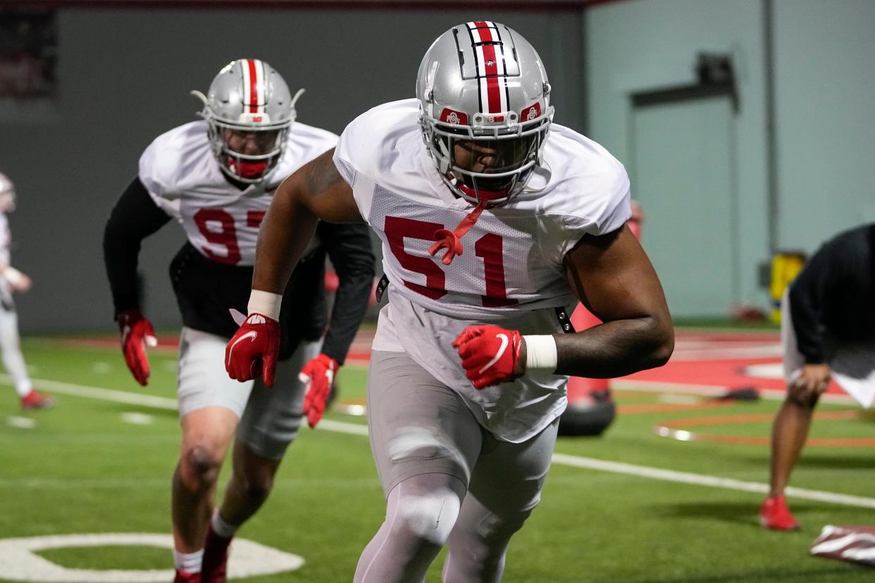 Ohio State Buckeyes defensive tackle Mike Hall (51) and defensive lineman Noah Potter (97) run drills during a spring football practice at the Woody Hayes Athletics Center in Columbus on March 22, 2022.