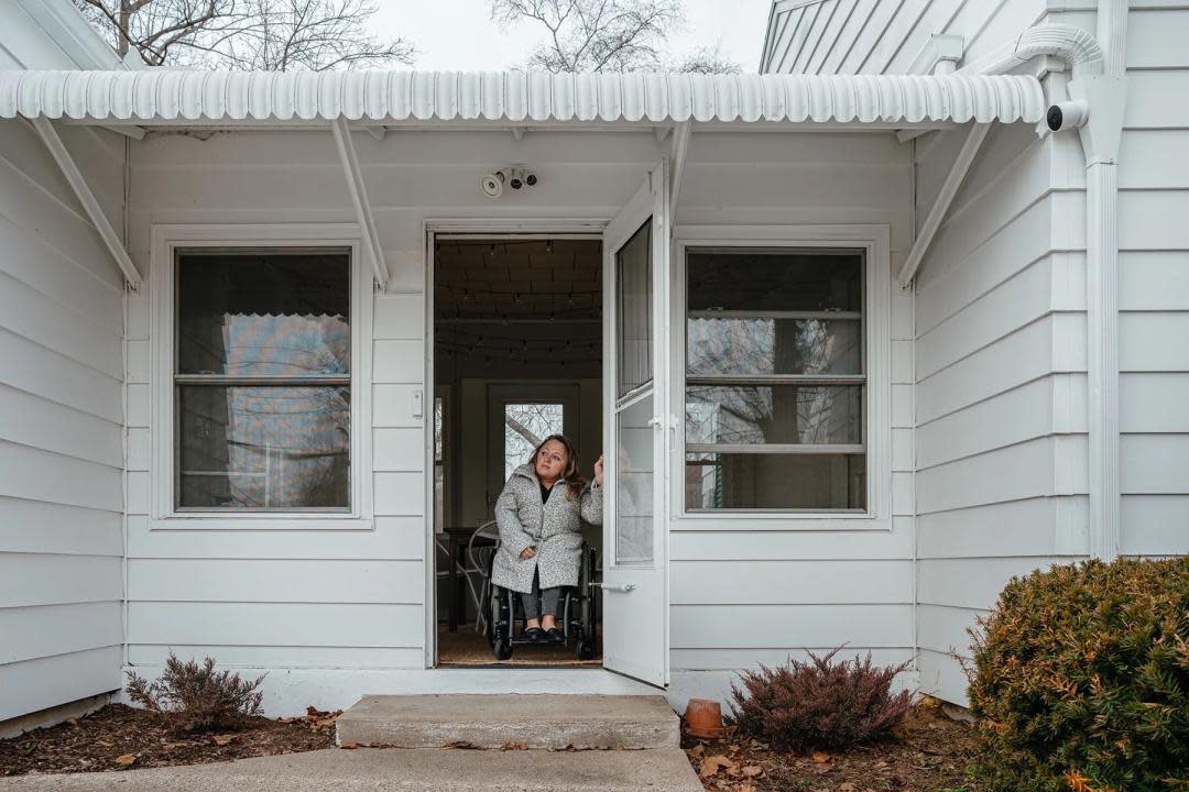 photo showing Voorde at the entrance to her home