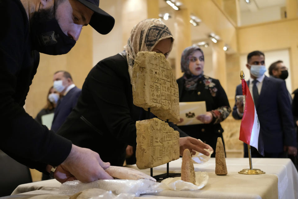 Iraqi antiquities are put on display during a ceremony held at the National Museum of Beirut before 337 artifacts were handed over by Lebanese Minister of Culture Mohammed Murtada to Iraq’s ambassador to Lebanon, in Beirut, Lebanon, Sunday, Feb. 6, 2022. Until they were handed over, the artifacts had been kept at the private Nabu Museum in north Lebanon. (AP Photo/Bilal Hussein)