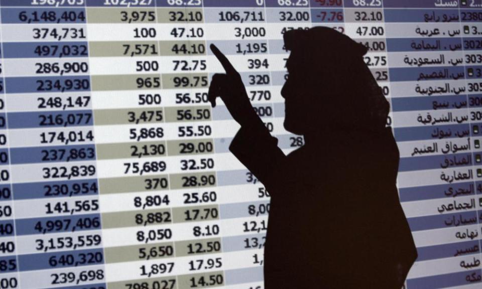 A stock trader in front of a monitor in Riyadh