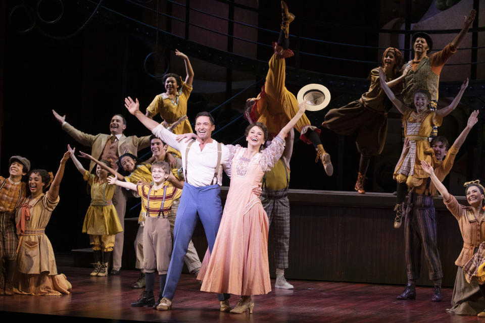 This image released by O & M Co./DKC shows Hugh Jackman, foreground left, and Sutton Foster with the cast during a production of "The Music Man" in New York. (Julieta Cervantes/O & M Co./DKC via AP)