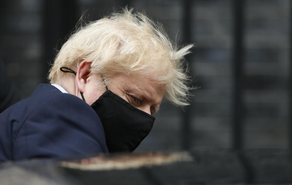 Prime Minister Boris Johnson leaves 10 Downing Street for the House of Commons wearing a mask.