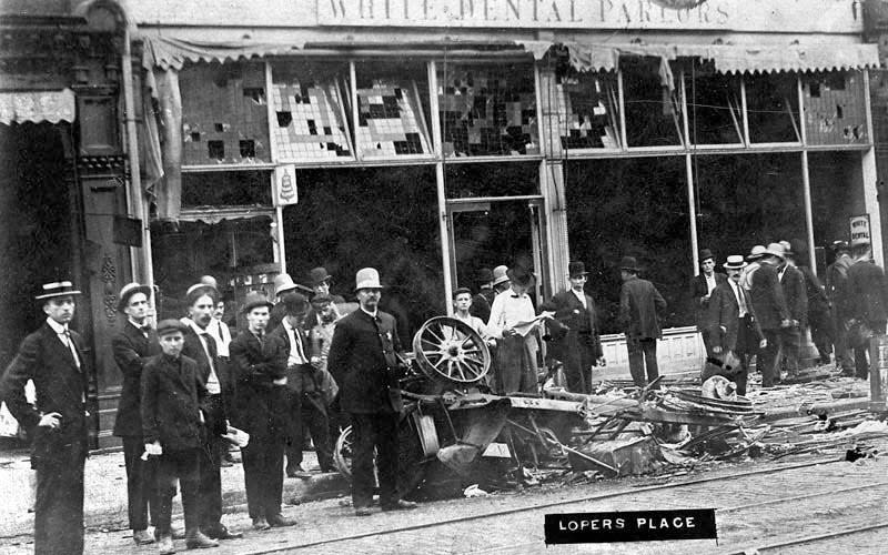 Harry Loper's restaurant at 223 S. Fifth Street in Springfield, Ill., appears demolished and his car destroyed by rioters in 1908.